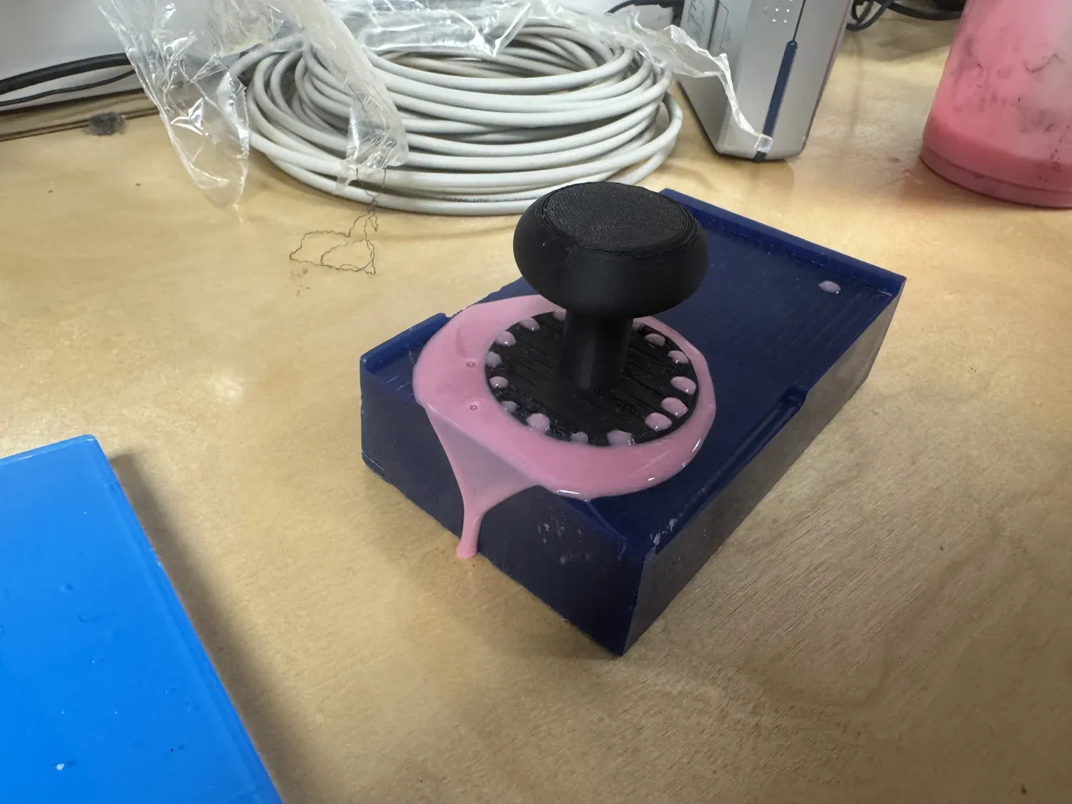 A teammate's 3D-printed joystick mold with pink silicone from the shared batch