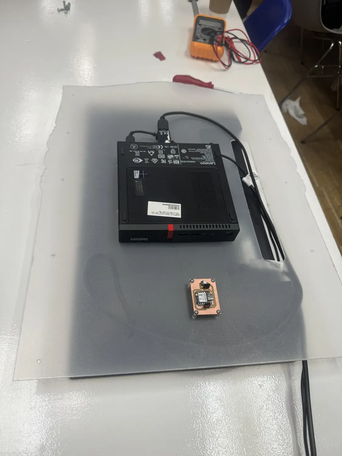 The integrated back of Maya's Mirror: frosted laser-cut acrylic panel carrying the VESA-mounted Lenovo mini PC and the milled copper sensor node