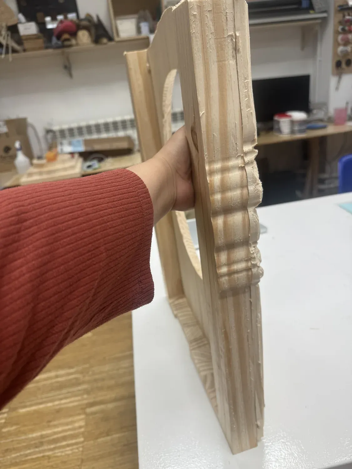 The carved wooden frame held edge-on, showing the decorative molding profile