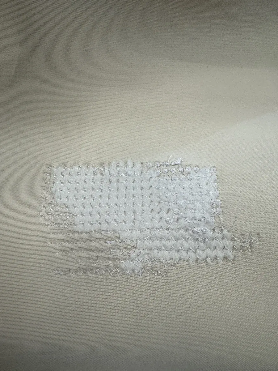 Back of embroidery showing dense stitch work