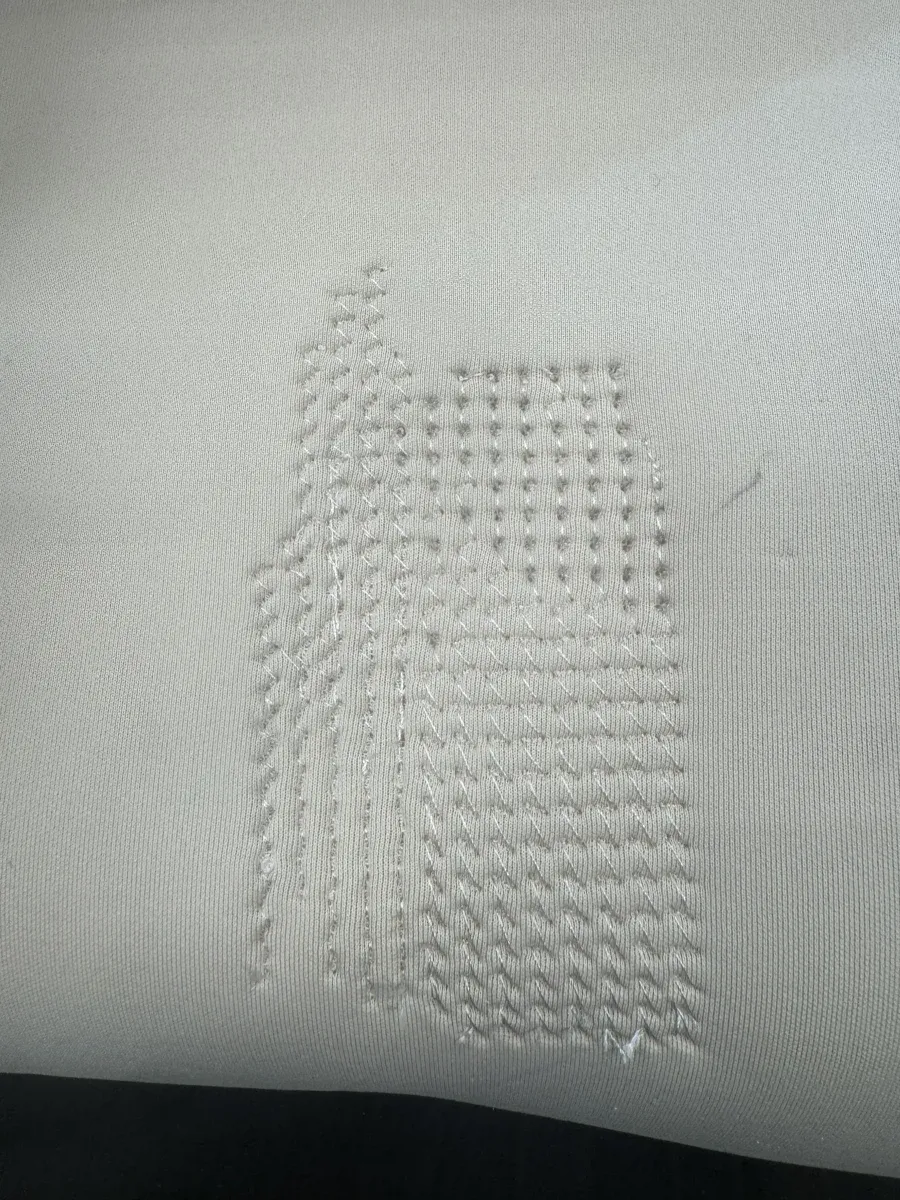 Finished embroidery front showing smell pattern with visible stitch types