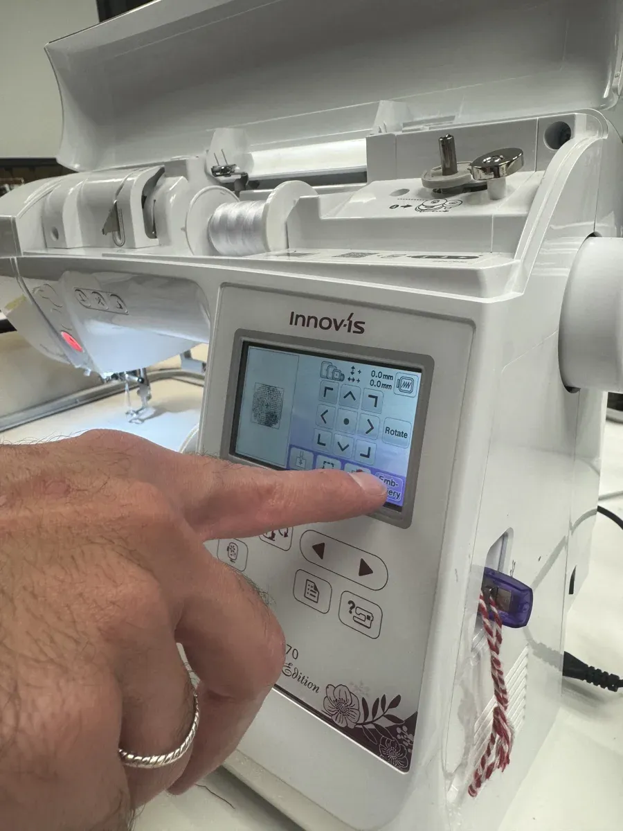 Machine screen showing embroidery mode with rotate and direction controls