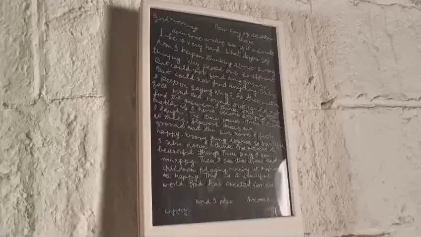 Maya's handwritten letter laser-marked into acrylic