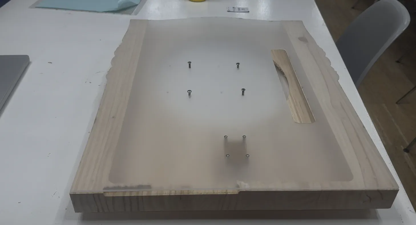 The back of the assembled mirror showing the pocket structure, VESA screws and handle slot