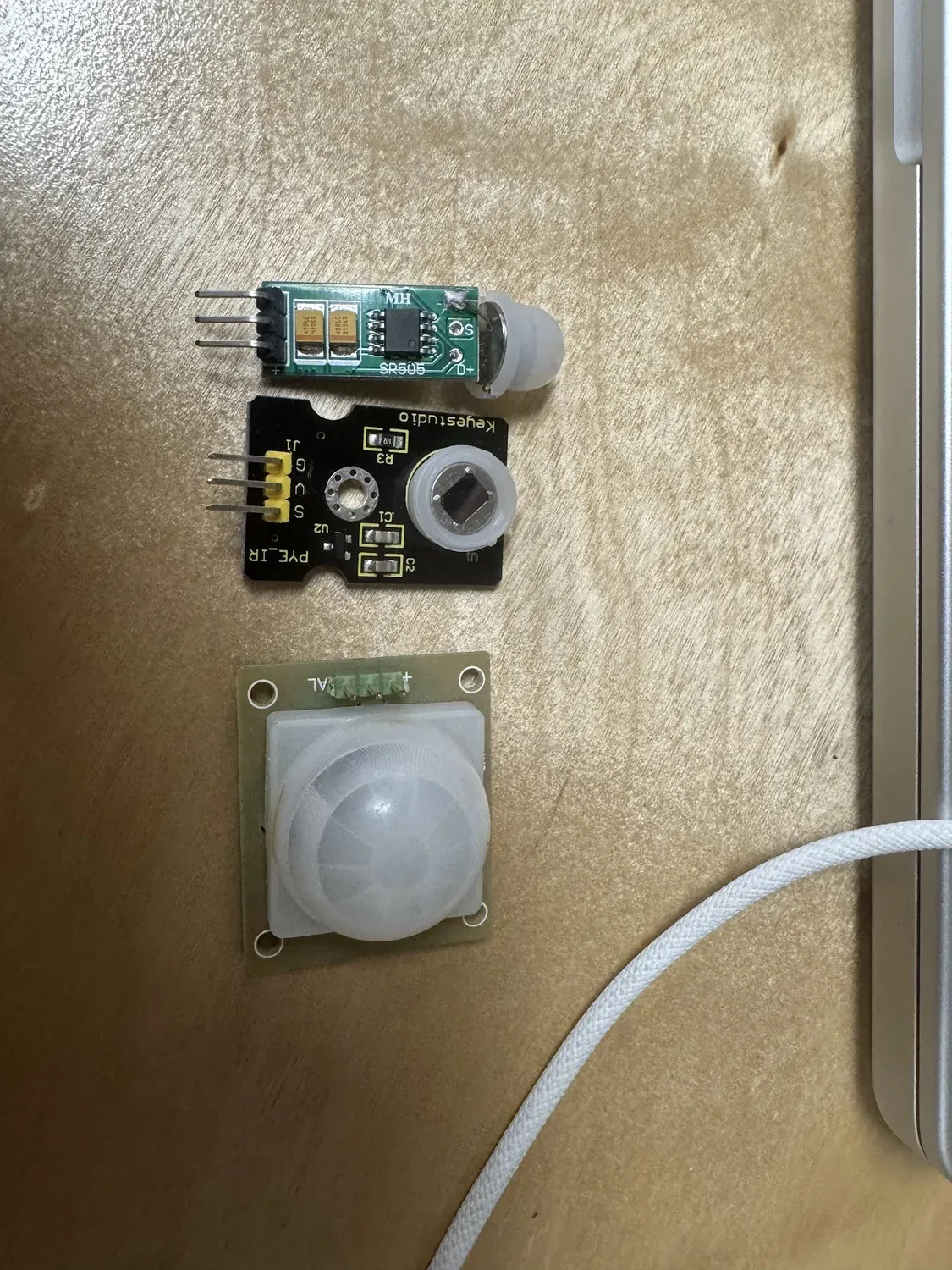 Three motion/IR sensors side by side: SR505, Keyestudio PYE_IR, and an HC-SR501 PIR dome