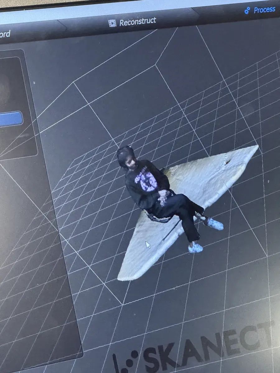 Full-body 3D scan reconstruction in Skanect showing a seated person