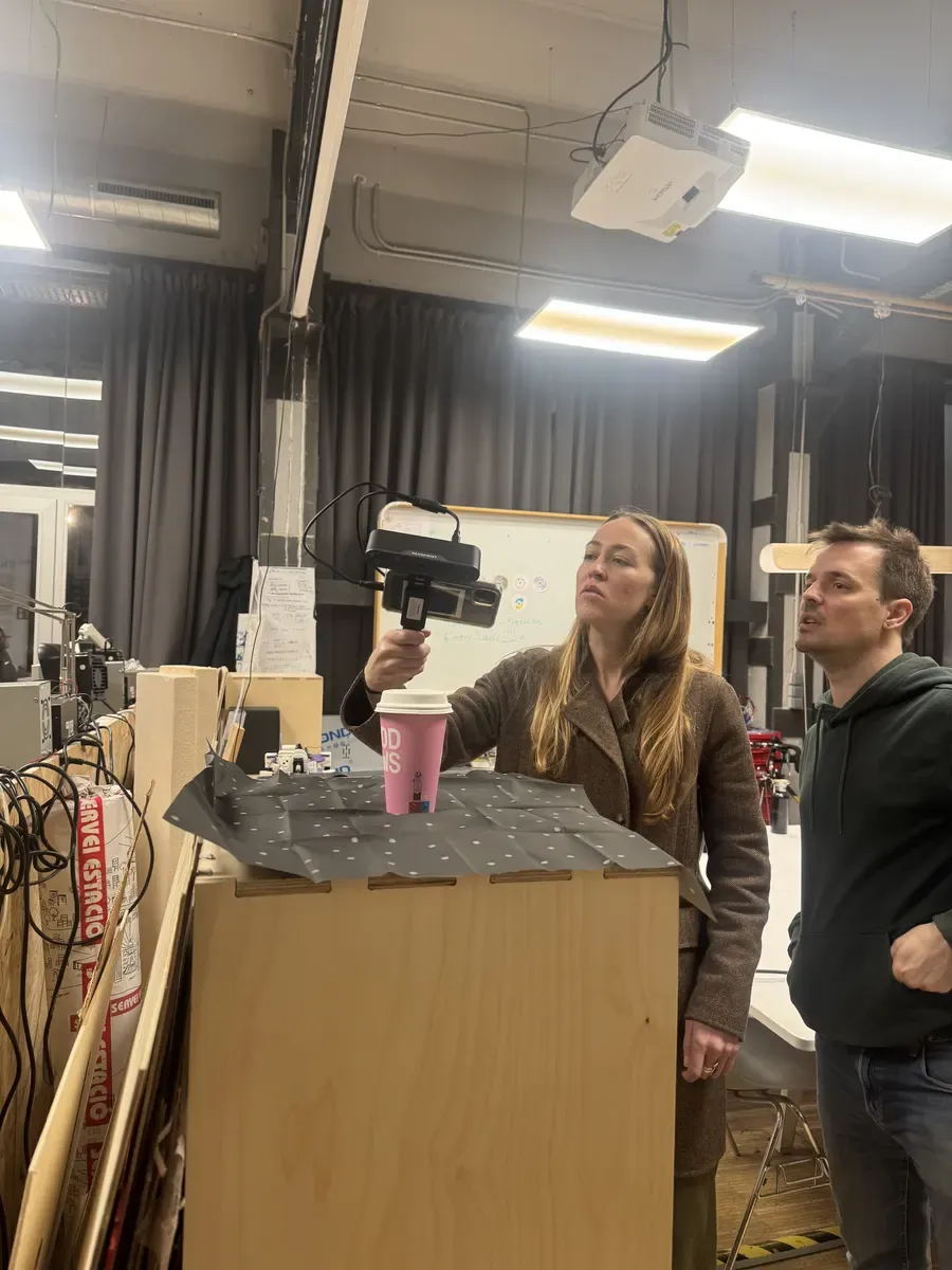 Instructor scanning a coffee mug on a dotted reference mat