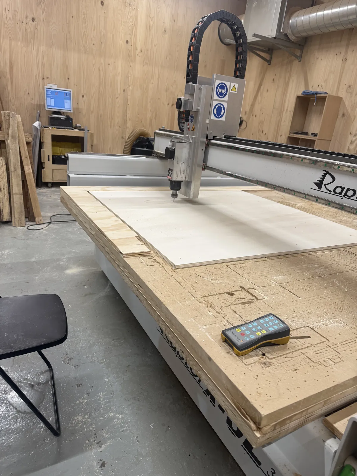 1220×1217mm plywood fixtured to the Raptor bed, remote pendant visible