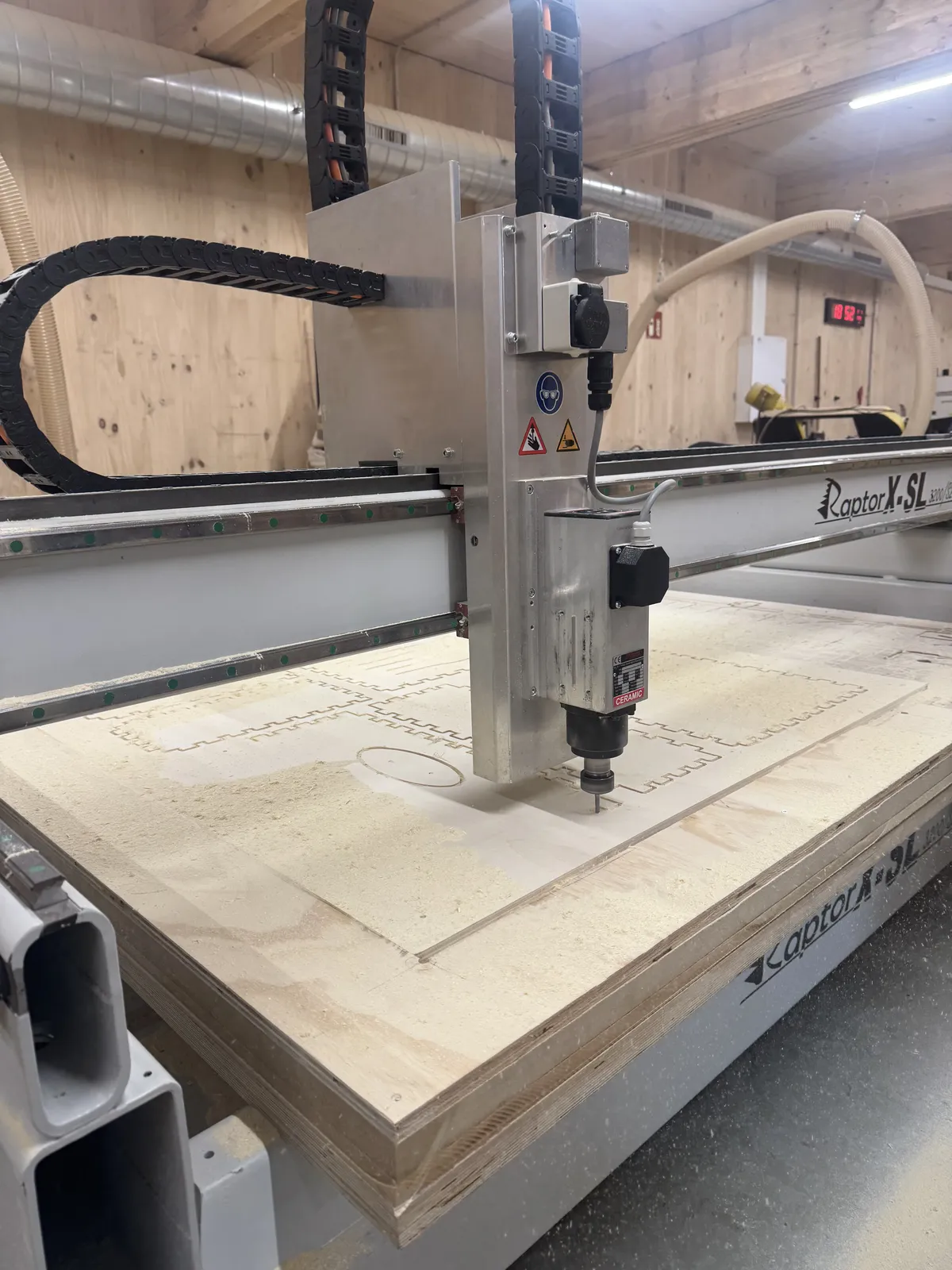 Raptor mid-cut, finger joints and ellipse sound hole emerging from the plywood