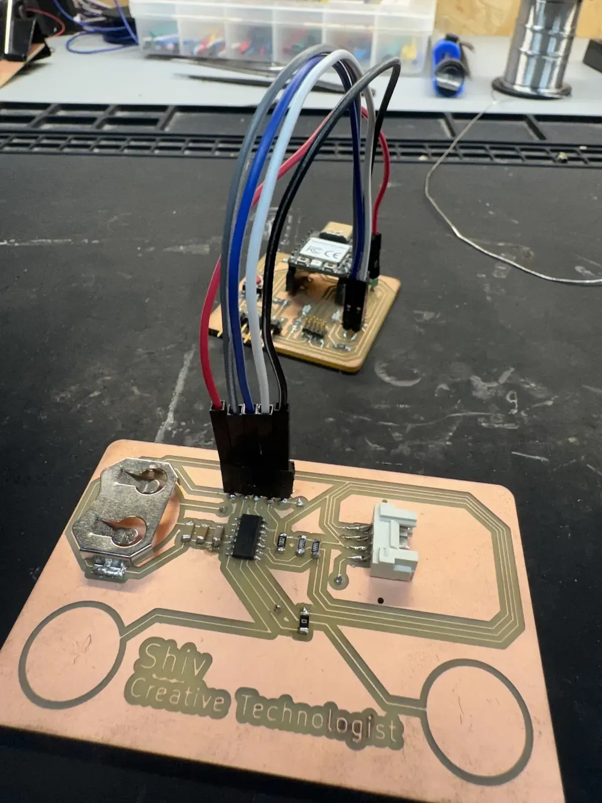PCB business card connected to Quentorres, copper touch pads, OLED header, CR2032 holder visible