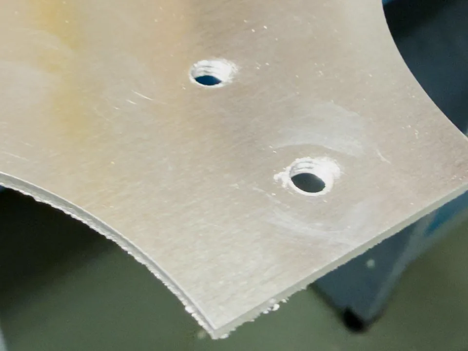 Threaded mounting holes in the laser-cut aluminum sheet