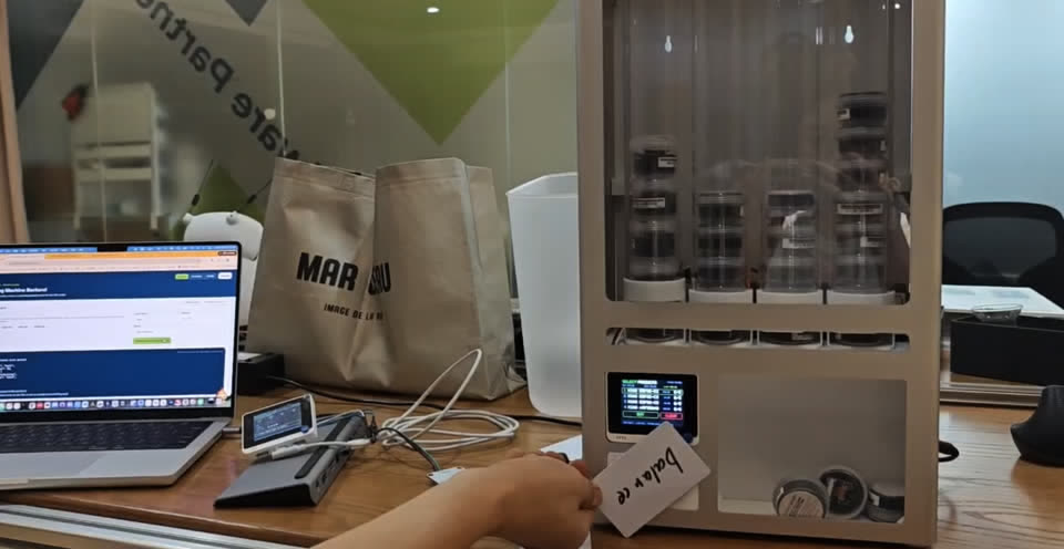 Real operation — Balance card tapped; machine shows product selection menu
