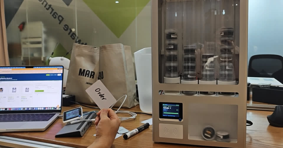 Real operation — Order card tapped on the four-column XIAO vending machine