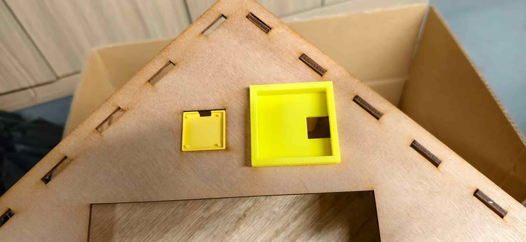 Close-up: OLED holder snap-fit in the wooden opening