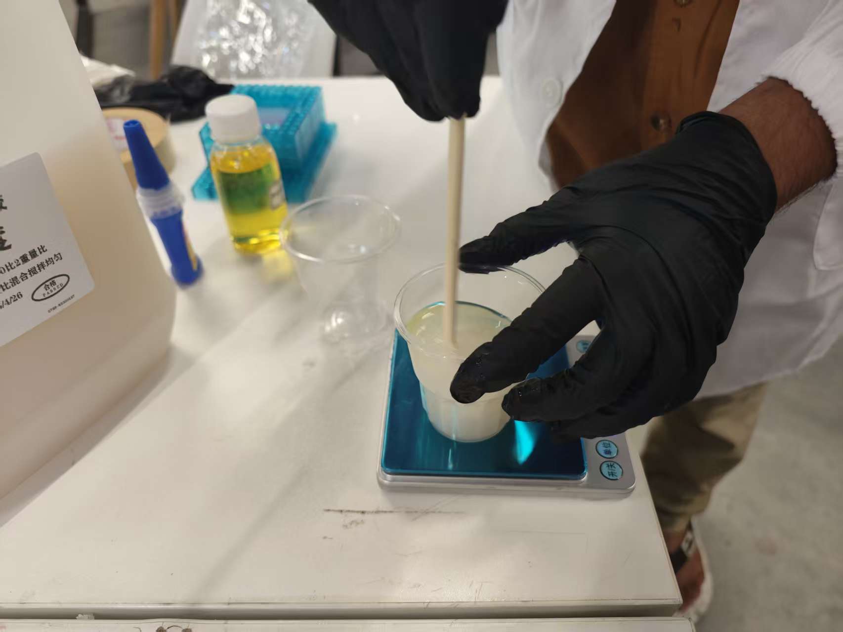 Weighing and stirring the catalyzed mix—this is the step I skipped on the cloud pour