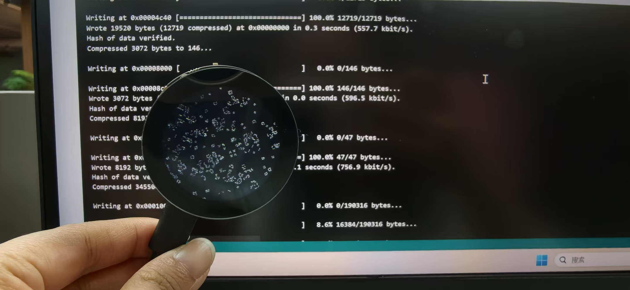 Early bring-up: flashing firmware while the round display shows a test pattern