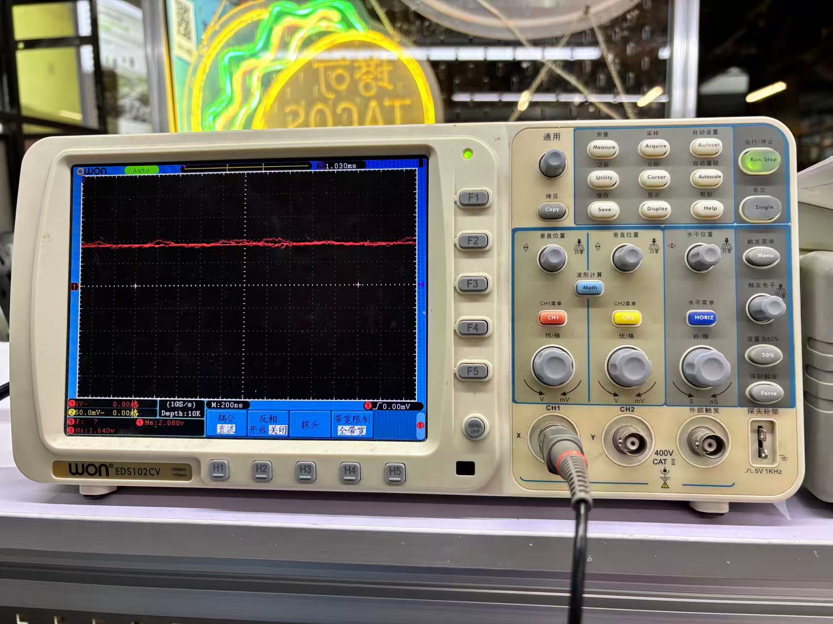 OWON EDS102CV full front panel — vertical, horizontal, trigger controls and CH1 menu