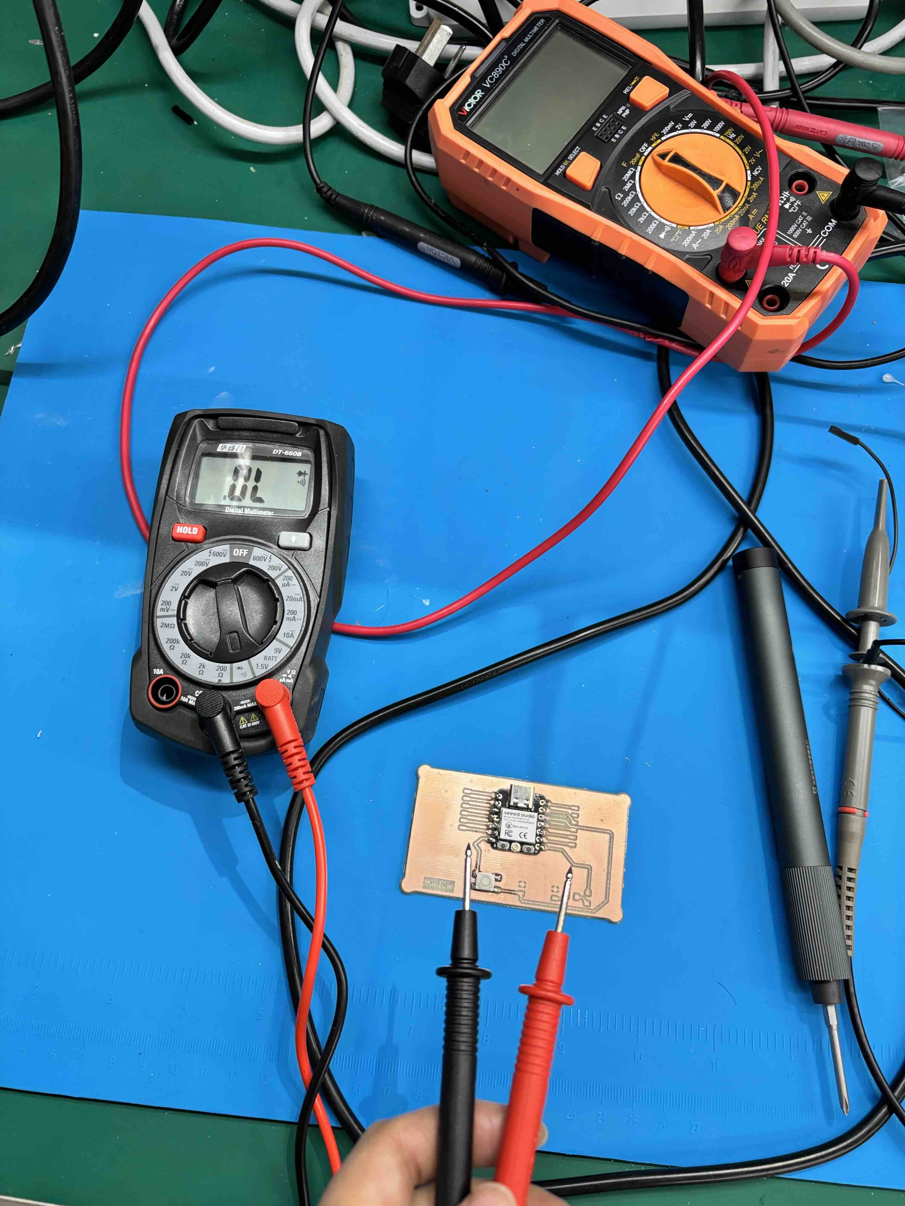 Digital multimeter measuring voltage on a breadboard circuit