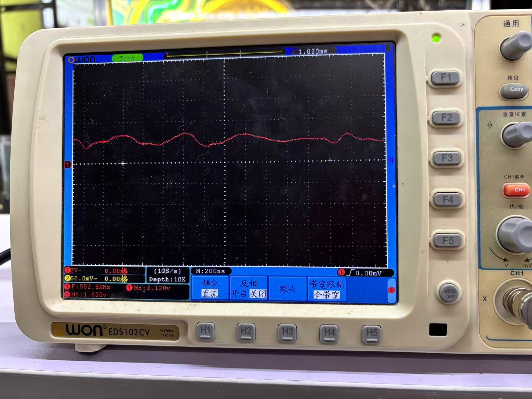 OWON EDS102CV oscilloscope displaying a probed signal with frequency and voltage measurements