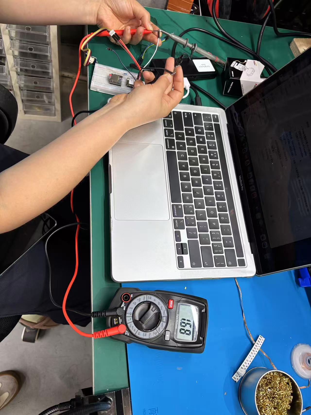 Multimeter and oscilloscope probe measuring NTC sensor circuit on breadboard