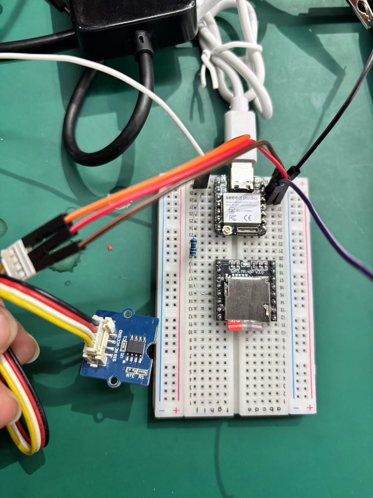 Seeed XIAO on breadboard wired to NTC R1 temperature sensor module