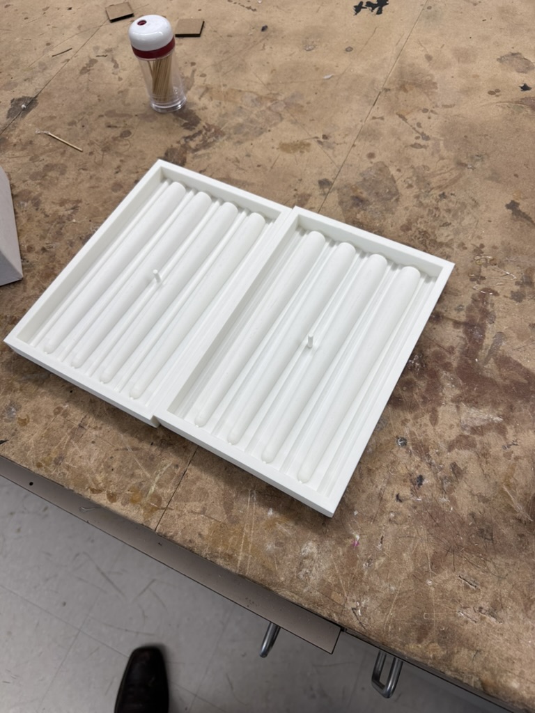 3D printed mold halves after sanding through 220, 330, and 440 grit