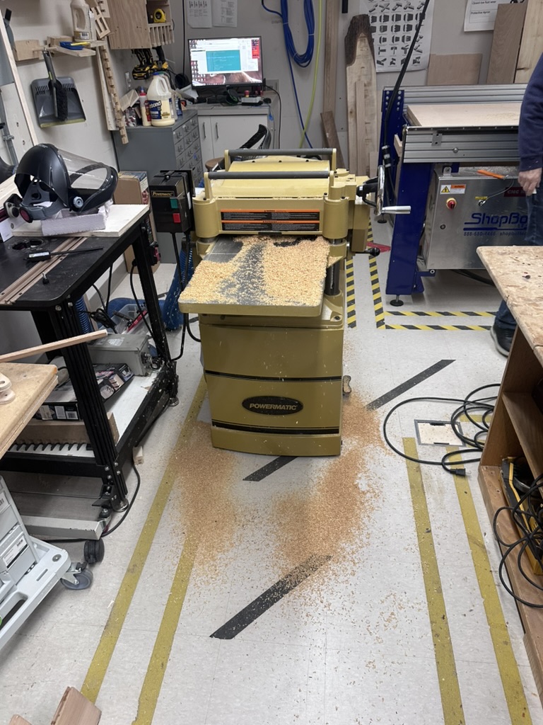 Running cedar boards through the thickness planer