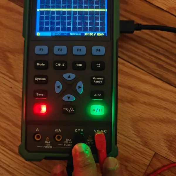 Oscilloscope with probes connected showing signal activity