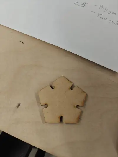 Laser-cut pentagon piece with interlocking grooves