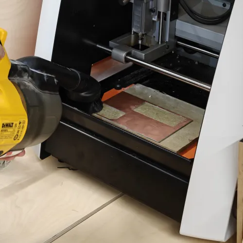 Vacuuming the SRM-20 bed with a DeWalt hoover to clear previous milling dust