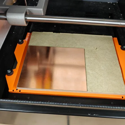 Copper board secured with double-sided tape on the SRM-20 bed, ready for milling