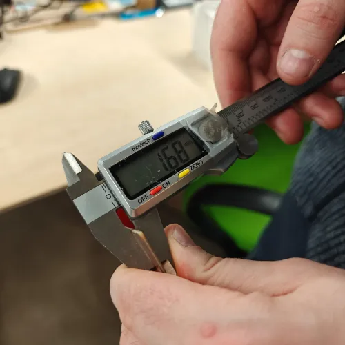 Digital calipers measuring the copper board thickness at 1.68mm