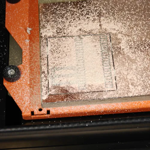 Outline cut complete - board separated from stock, covered in FR1 dust