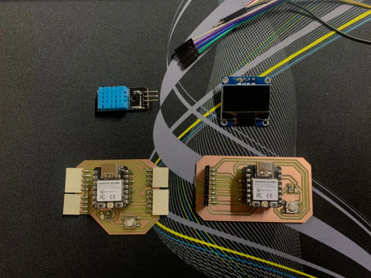 All components laid out — two XIAO ESP32-C3 boards, DHT11 sensor, and 0.96" OLED display