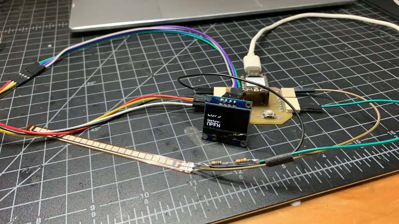 Full gesture monitor setup with flex sensor, OLED and XIAO ESP32-C3 on the cutting mat