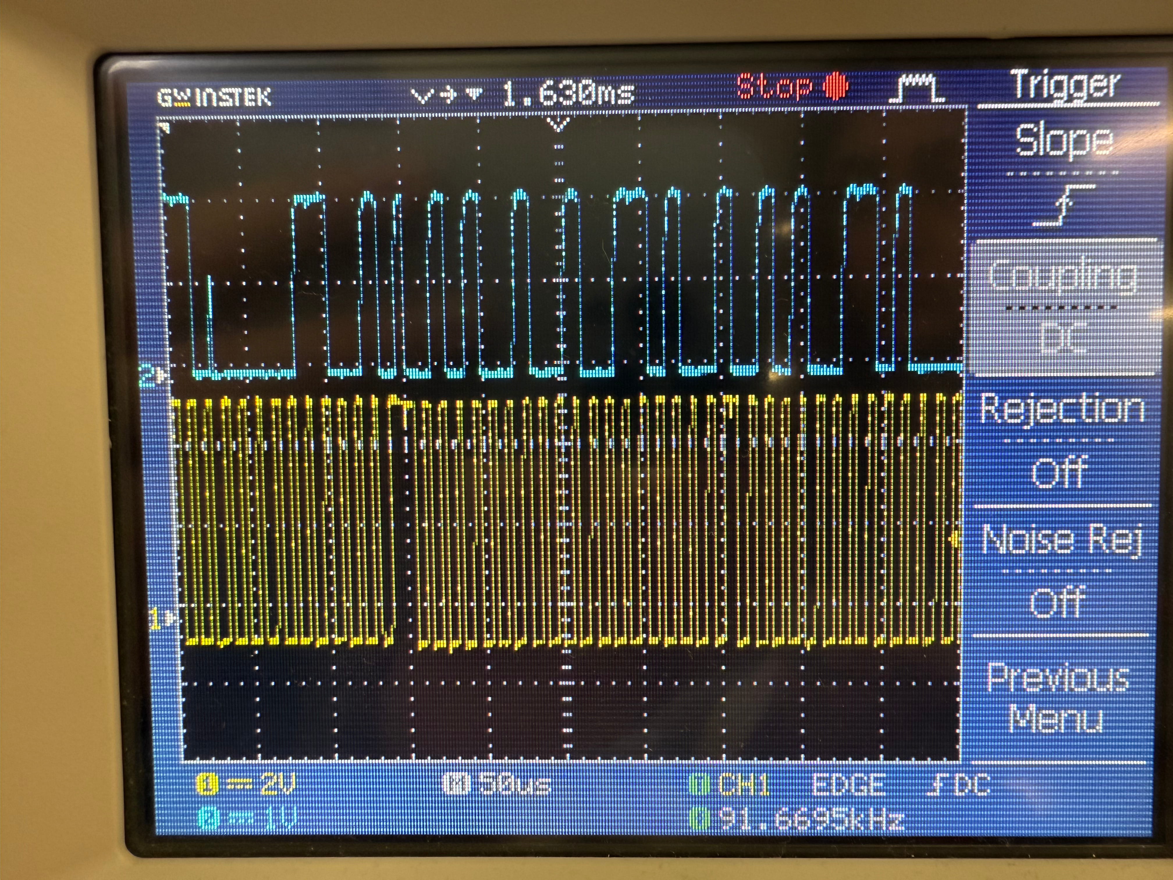 Oscilloscope showing SDA and SCL I2C waveforms โ white surface