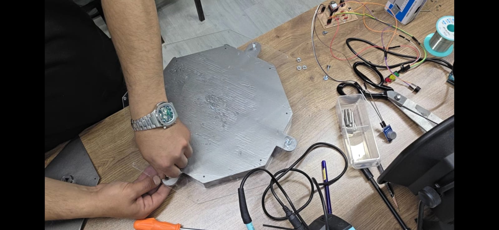 Fitting the metal shield element to the enclosure lid
