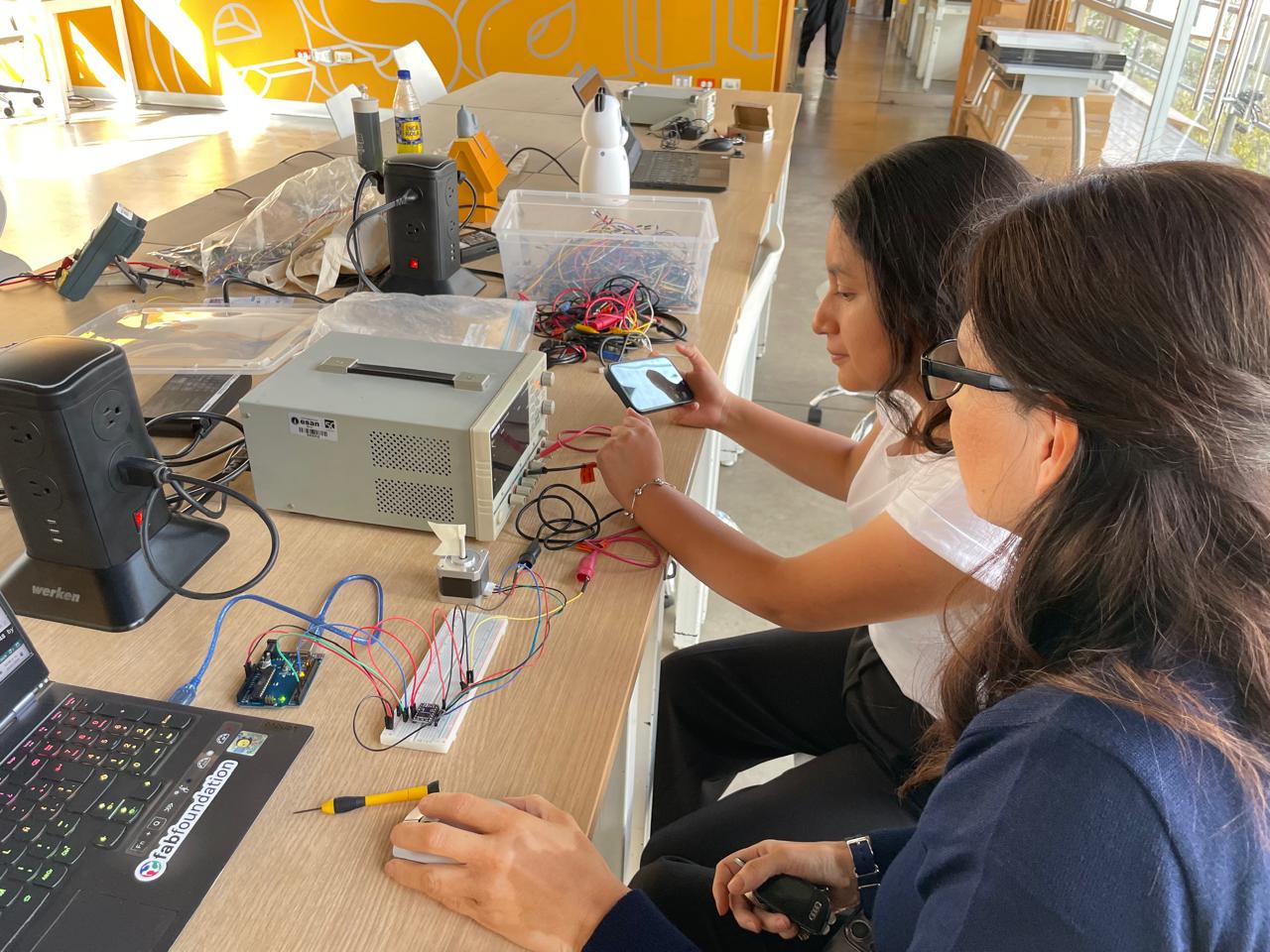 Students testing the stepper motor circuit and measuring power consumption