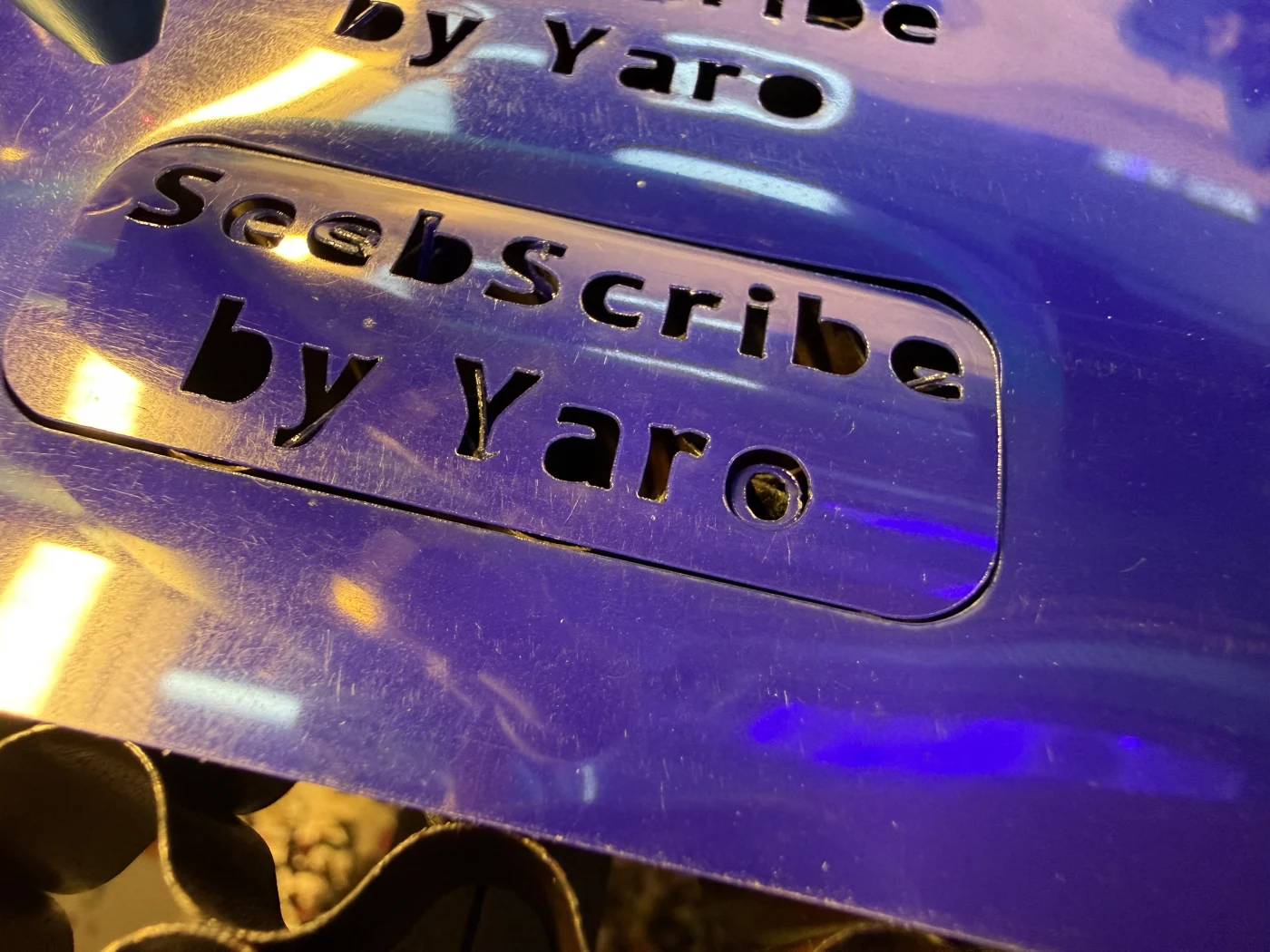 Laser-cut vinyl sticker after cutting the Seebscribe by Yaro logo