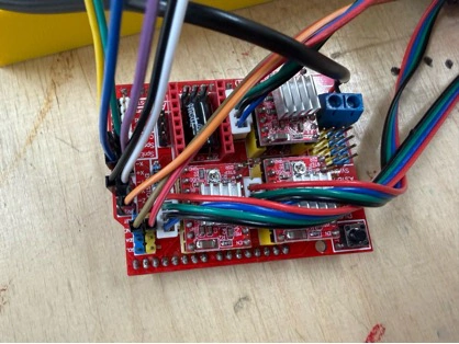 Title: image13.jpeg - Description: Red CNC shield on the bench, stepper and servo cables being routed before it gets mounted inside the frame.