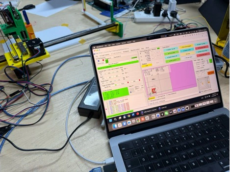 Title: image22.jpeg - Description: GRBL Plotter open on the laptop next to the running Coloured Plotter — calibration job loaded, work area shown in pink.