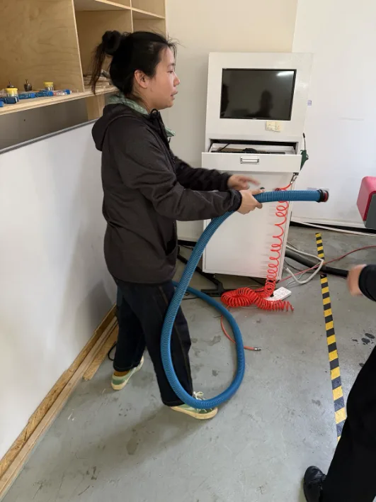 Pulling out the vacuum hose for bed cleaning