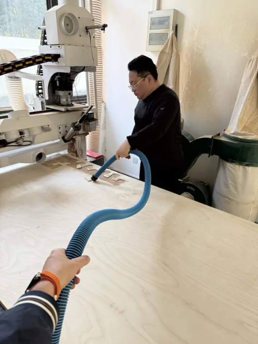 Vacuuming the CNC bed surface