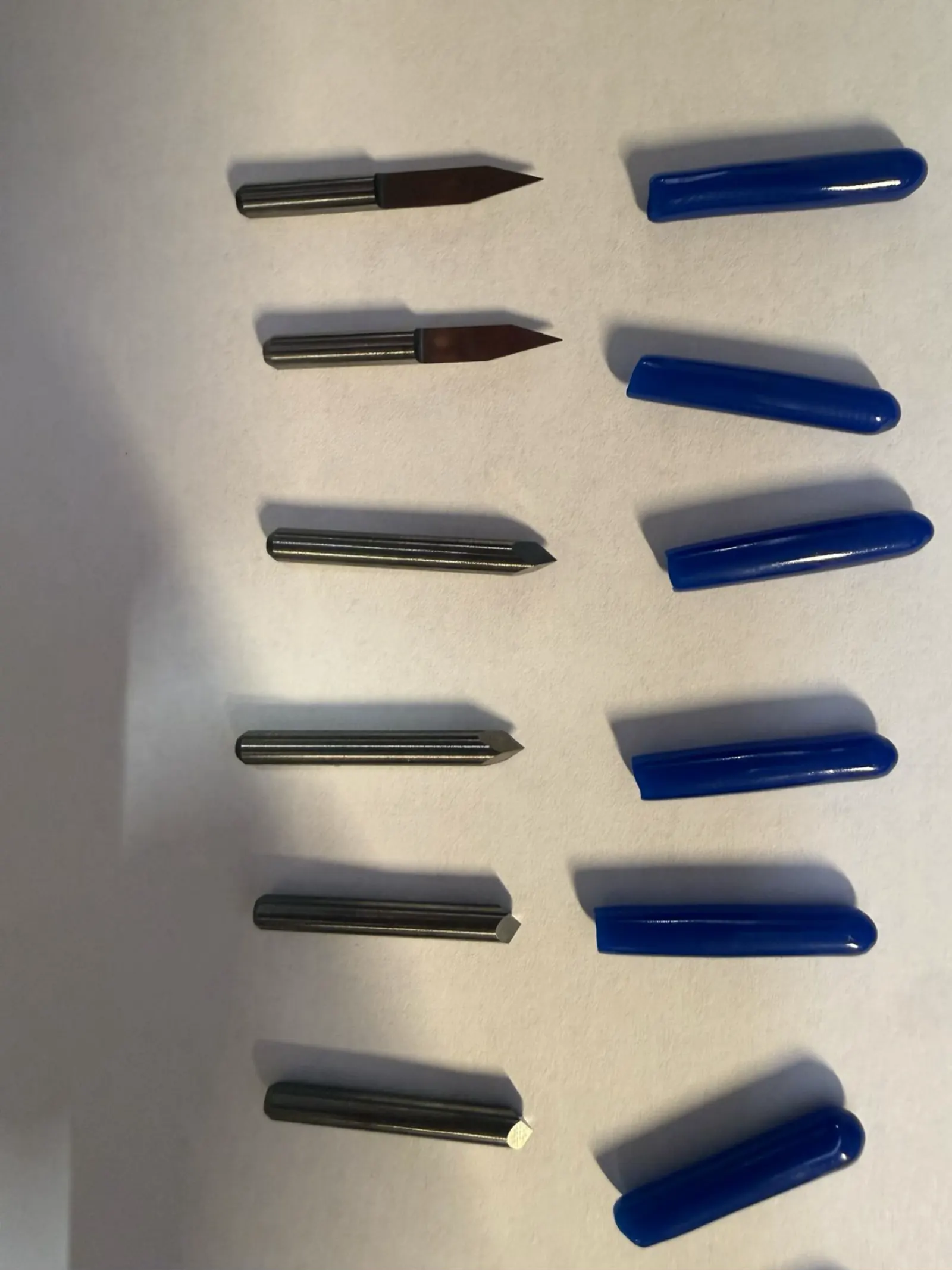 Close-up of the V-bit engraving bits sorted by size – the sharp angled tip mills the isolation channels between copper traces