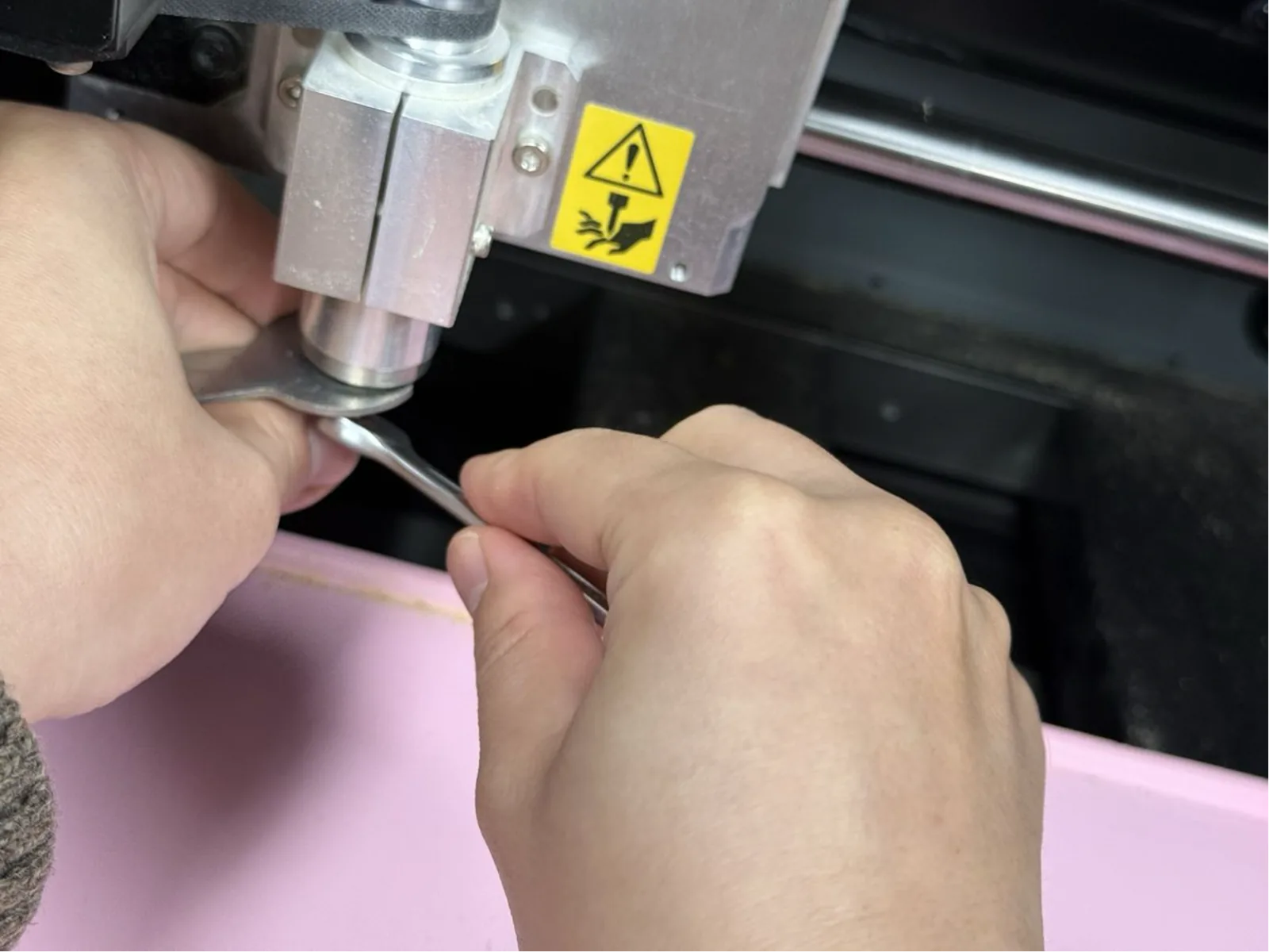 Installing the V-bit engraving tool into the Roland MDX-40A spindle collet – first hand-tight, then wrench-tightened