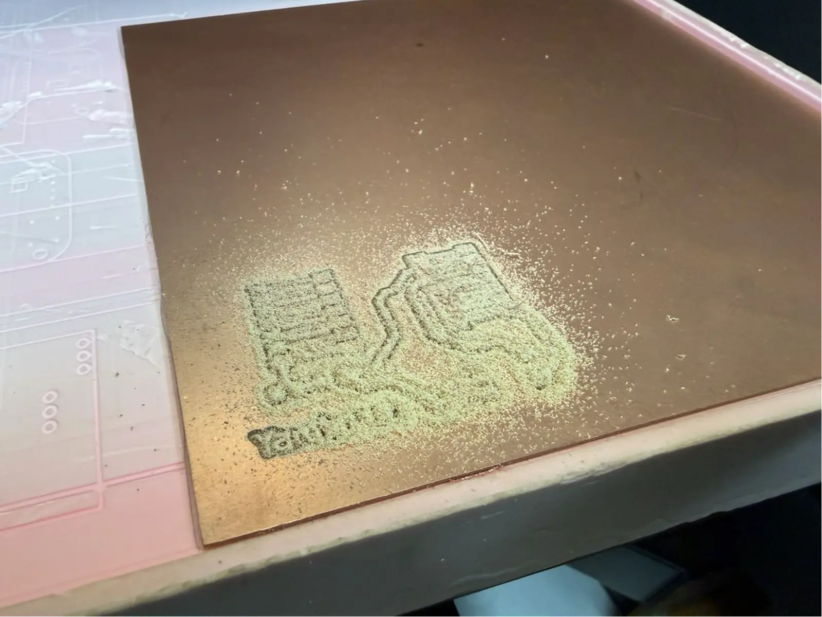 Milling in progress – the "Yaroboard" name text and the first circuit traces becoming visible as copper is removed