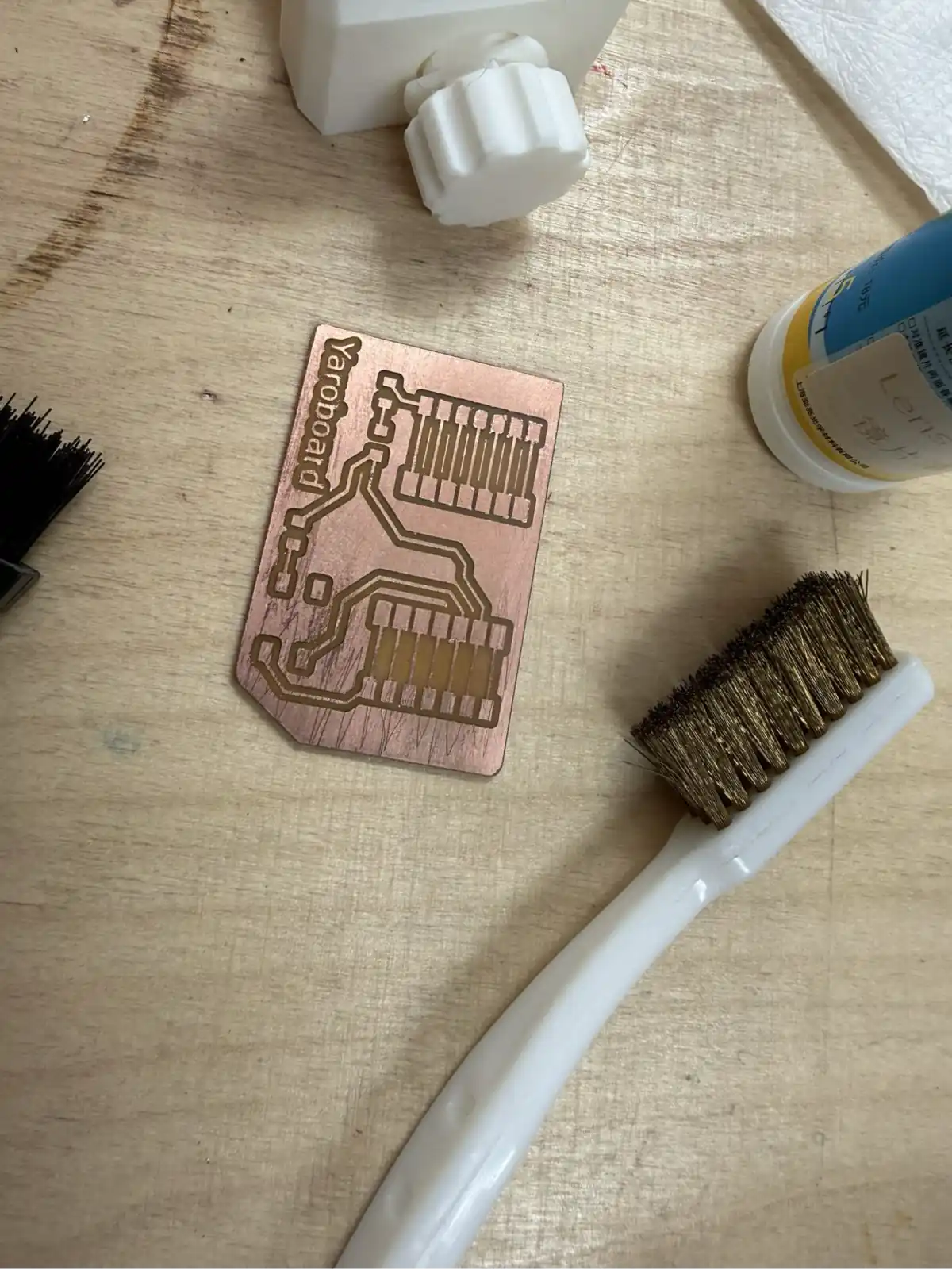 Freshly milled Yaroboard being cleaned with a brass wire brush and IPA – the circuit traces are clean and well-defined