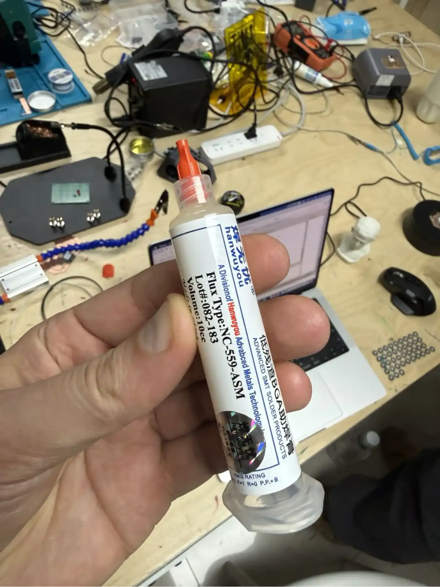 Syringe of solder paste – applied in small dots to SMD pads before component placement and reflow