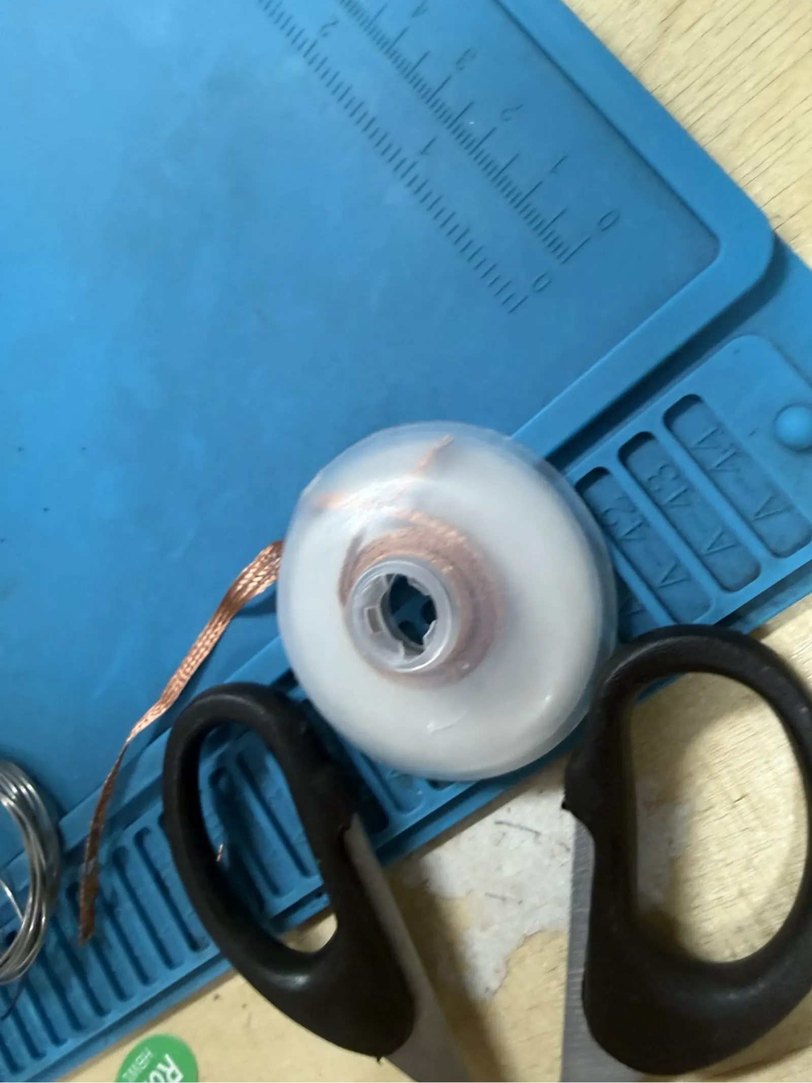 Roll of desoldering wick (copper braid) with scissors – used to remove excess solder or correct solder bridges between traces