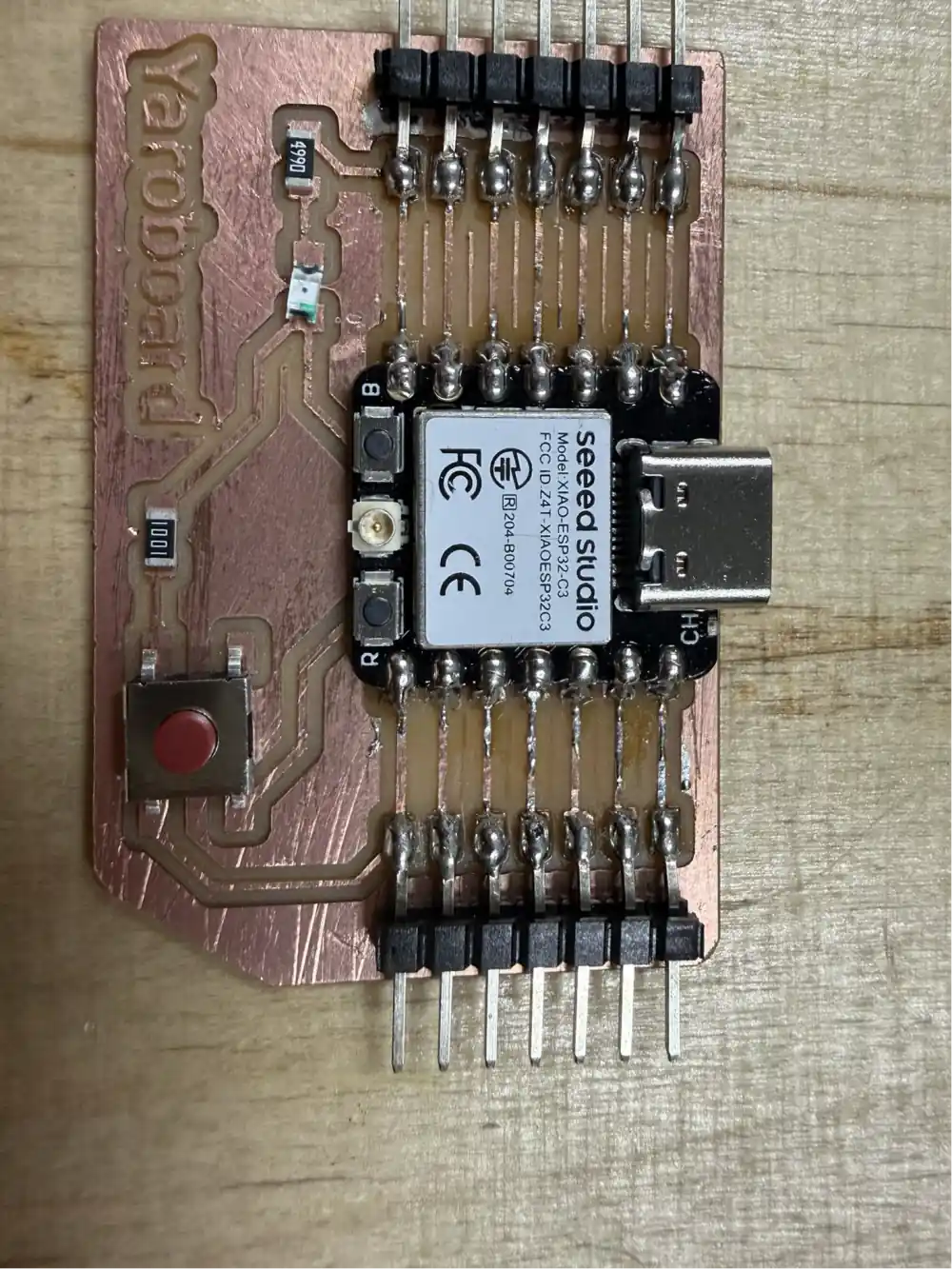 Board with the majority of components soldered – XIAO module, tactile button, and passive SMD components all in place